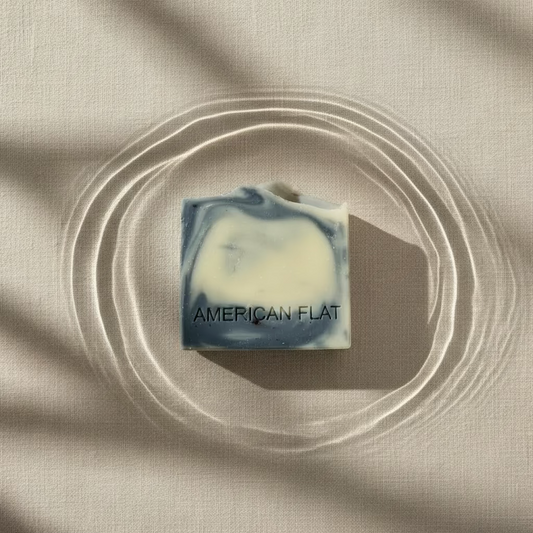White colored soap swirled with charcoal on a neutral background