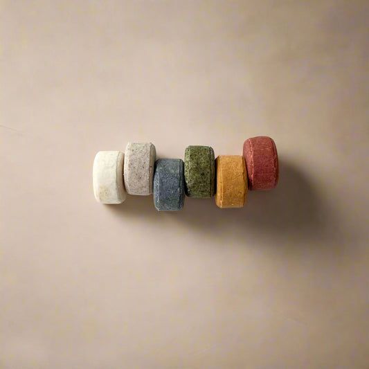 Colorful set of six mini solid shampoo bars for a variety of hair types on white background
